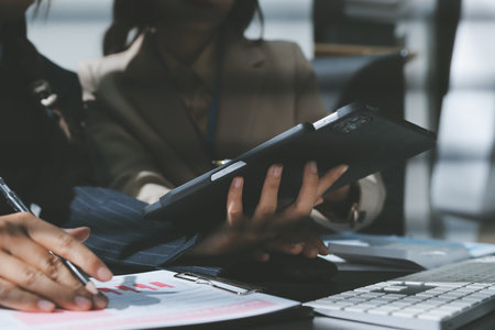 Close up high angle Asian businesswoman working with her coworker in meeting roomの写真素材