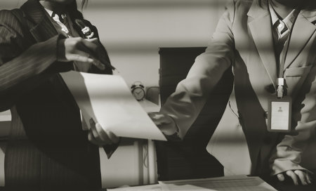 Close up high angle Asian businesswoman working with her coworker in meeting roomの写真素材