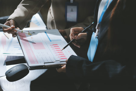 Close up high angle Asian businesswoman working with her coworker in meeting roomの写真素材