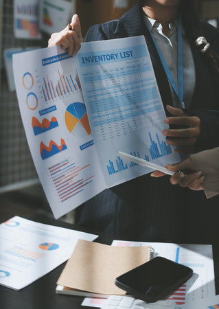 Close up high angle Asian businesswoman working with her coworker in meeting roomの写真素材