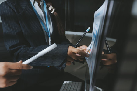 Close up high angle Asian businesswoman working with her coworker in meeting roomの写真素材