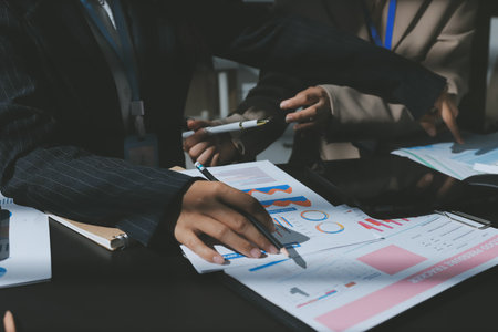 Close up high angle Asian businesswoman working with her coworker in meeting room