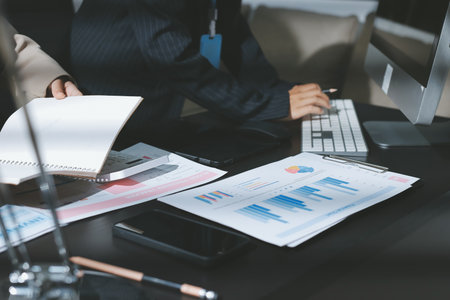 Close up high angle Asian businesswoman working with her coworker in meeting roomの写真素材