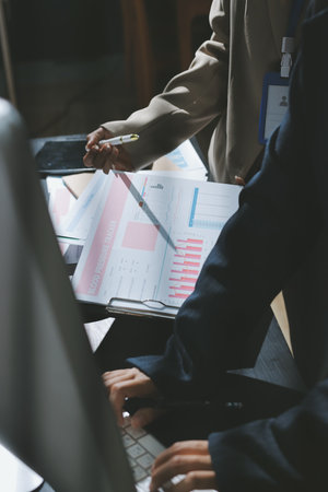 Close up high angle Asian businesswoman working with her coworker in meeting roomの写真素材