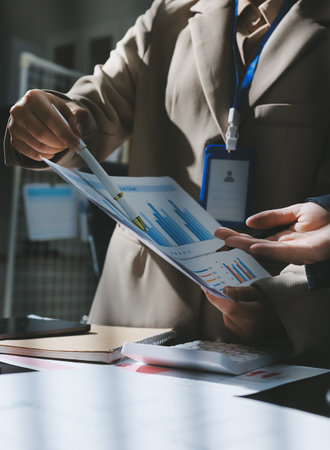 Close up high angle Asian businesswoman working with her coworker in meeting roomの写真素材