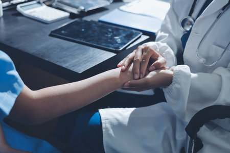 Male doctors shake hands with patients encouraging each other and praying for blessings. To offer love, concern, and encouragement while checking the patient's health. concept of medicineの写真素材