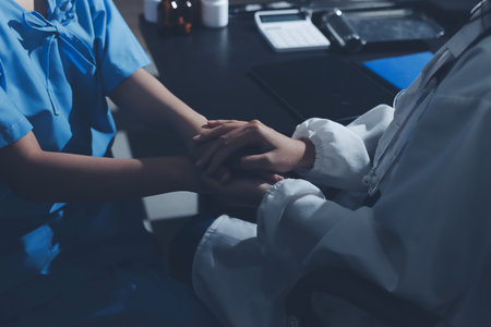 Male doctors shake hands with patients encouraging each other and praying for blessings. To offer love, concern, and encouragement while checking the patient's health. concept of medicineの写真素材