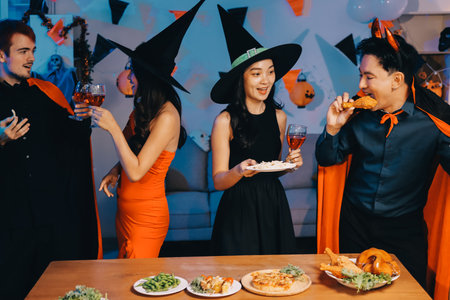 Joyful office Halloween party with coworkers in costumes, celebrating with drinks and laughter, fostering teamwork and festive spiritの写真素材