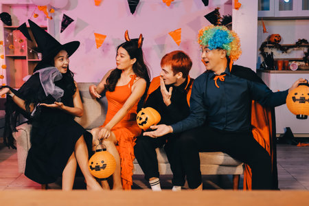 Joyful Halloween party with coworkers in costumes, celebrating with drinks and laughter, fostering teamwork and festive spiritの写真素材