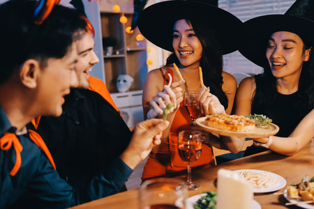 Joyful office Halloween party with coworkers in costumes, celebrating with drinks and laughter, fostering teamwork and festive spiritの写真素材