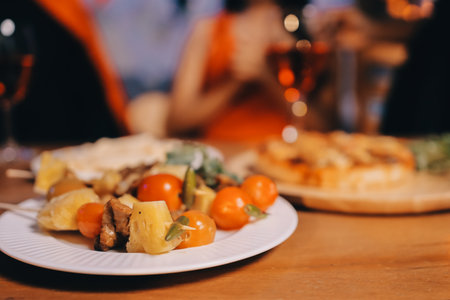 Joyful Halloween party with coworkers in costumes, celebrating with drinks and laughter, fostering teamwork and festive spiritの写真素材