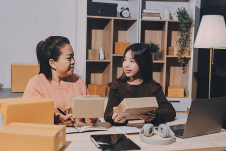 Asian woman describe selling clothes on camera live broadcast on social network at home, Online selling clothes on social media. Blogger woman influencer, SME retail store owner.の写真素材