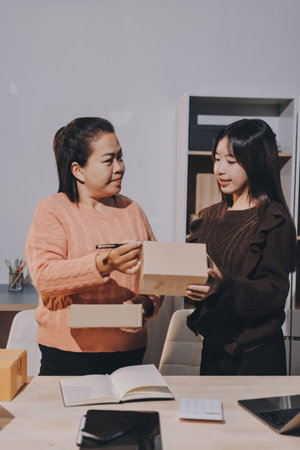 Asian woman selling clothes on camera live broadcast on social network at home, Online selling clothes on social media. Blogger woman influencer, SME retail store owner.の写真素材