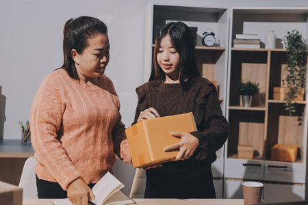 Asian woman describe selling clothes on camera live broadcast on social network at home, Online selling clothes on social media. Blogger woman influencer, SME retail store owner.の写真素材