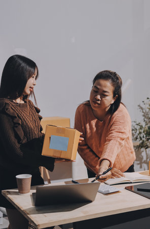 Asian woman selling clothes on camera live broadcast on social network at home. Online selling clothes on social media. Blogger woman influencer, SME retail store owner.の写真素材