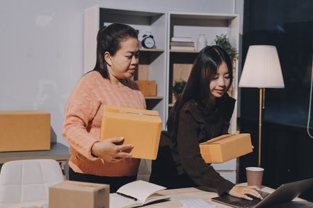 Asian woman describe selling clothes on camera live broadcast on social network at home, Online selling clothes on social media. Blogger woman influencer, SME retail store owner.の写真素材