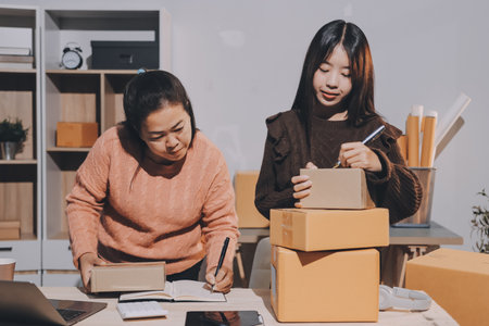 Asian woman selling clothes on camera live broadcast on social network at home, Online selling clothes on social media. Blogger woman influencer, SME retail store owner.の写真素材