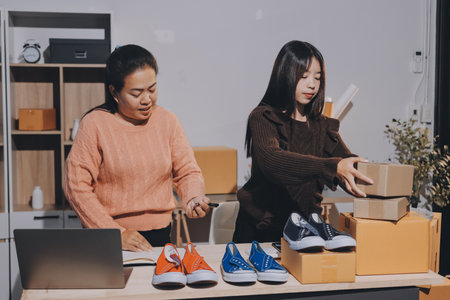 Asian woman selling clothes on camera live broadcast on social network at home, Online selling clothes on social media. Blogger woman influencer, SME retail store owner.の写真素材