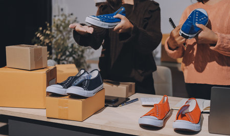 Asian woman selling clothes on camera live broadcast on social network at home, Online selling clothes on social media. Blogger woman influencer, SME retail store owner.の写真素材