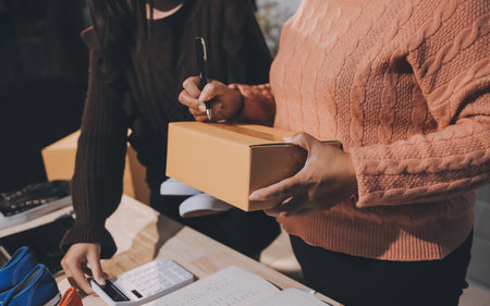 Asian woman describe selling clothes on camera live broadcast on social network at home, Online selling clothes on social media. Blogger woman influencer, SME retail store owner.の写真素材