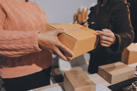 Asian woman selling clothes on camera live broadcast on social network at home, Online selling clothes on social media. Blogger woman influencer, SME retail store owner.の写真素材