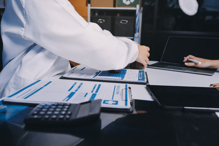 Group of doctors attending seminar in hospital lecture hall with senior physician giving medical presentation and professional training session on healthcare practicesの写真素材