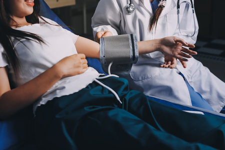 Nurse measuring blood pressure of elderly woman at table, closeup. Assisting senior generationの写真素材