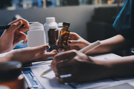 Group of doctors attending seminar in hospital lecture hall with senior physician giving medical presentation and professional training session on healthcare practicesの写真素材