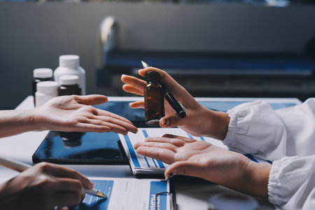 Group of doctors attending seminar in hospital lecture hall with senior physician giving medical presentation and professional training session on healthcare practicesの写真素材