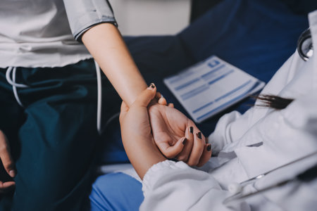 Nurse measuring blood pressure of elderly woman at table, closeup. Assisting senior generationの写真素材