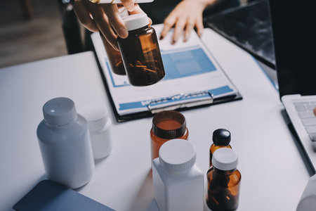Group of doctors attending seminar in hospital lecture hall with senior physician giving medical presentation and professional training session on healthcare practicesの写真素材