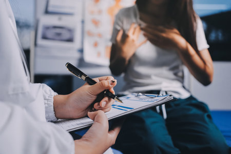 Compassionate Female Doctor Examining Senior Patient in Hospital Bed, Showing Empathy and Careの写真素材