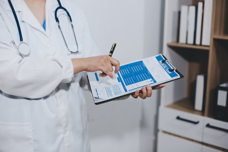 Portrait of female doctor, holding fileの写真素材