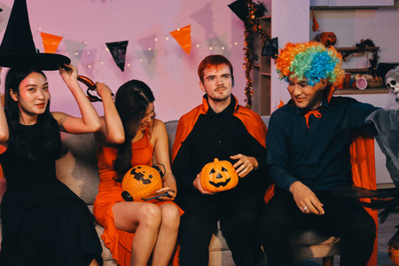 Joyful office Halloween party with coworkers in costumes, celebrating with drinks and laughter, fostering teamwork and festive spiritの写真素材