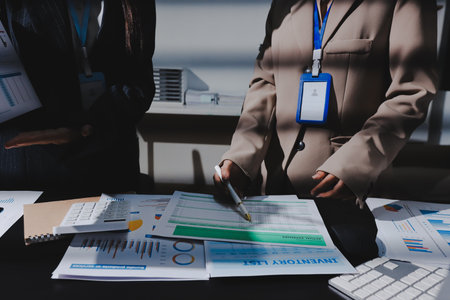 Close up high angle Asian businesswoman working with her coworker in meeting roomの写真素材