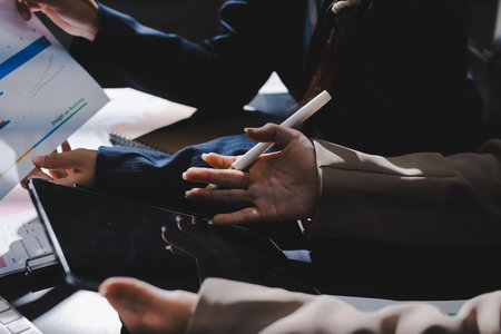Close up high angle Asian businesswoman working with her coworker in meeting roomの写真素材