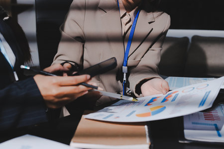 Close up high angle Asian businesswoman working with her coworker in meeting roomの写真素材