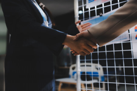 Business people shaking hands. Two business partners shaking hands after signing a contract.の写真素材