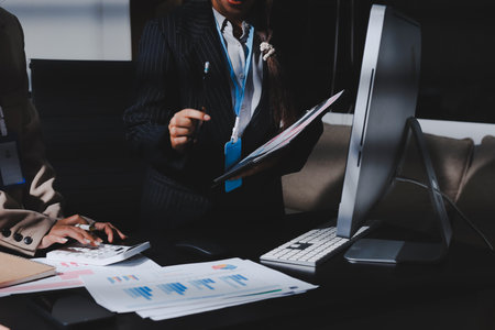 Close up high angle Asian businesswoman working with her coworker in meeting roomの写真素材