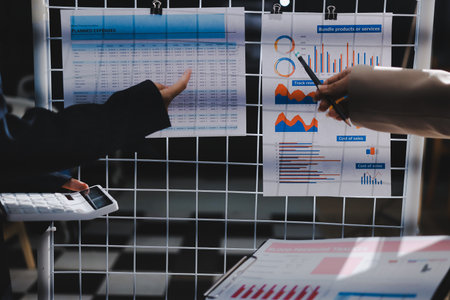 Close up high angle Asian businesswoman working with her coworker in meeting roomの写真素材