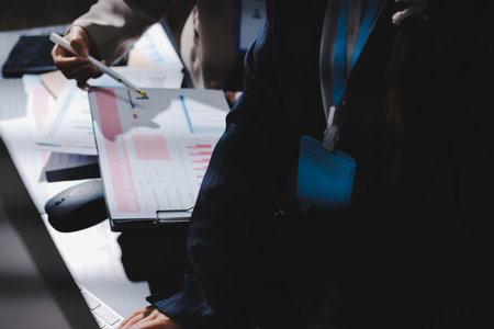 Close up high angle Asian businesswoman working with her coworker in meeting roomの写真素材