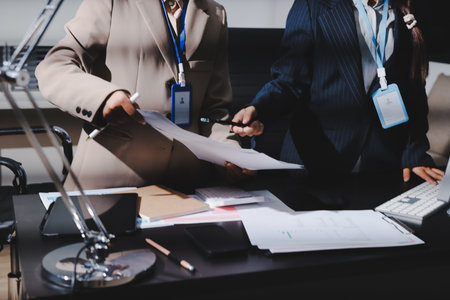Close up high angle Asian businesswoman working with her coworker in meeting roomの写真素材