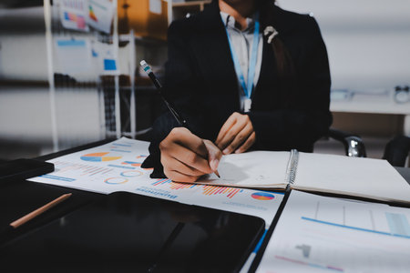Close up high angle Asian businesswoman working with her coworker in meeting roomの写真素材