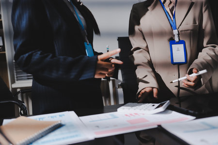 Close up high angle Asian businesswoman working with her coworker in meeting roomの写真素材