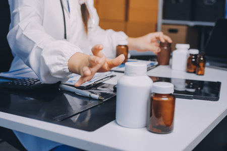 Group of doctors attending seminar in hospital lecture hall with senior physician giving medical presentation and professional training session on healthcare practicesの写真素材