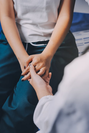 Doctor giving hope. Close up shot of young female physician leaning forward to smiling elderly lady...