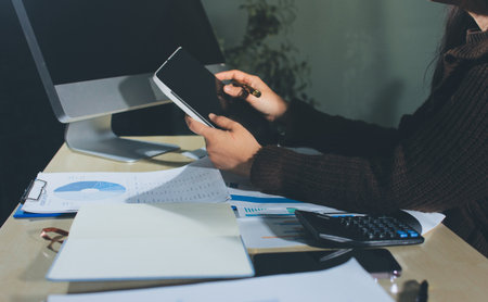 Close-up of businessman's hands making notes, chart, desk, office