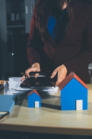 Customer signing a real estate contract in real estate agency.の写真素材