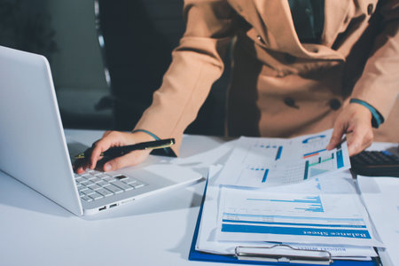 Close-up of businessman's hands making notes, chart, desk, officeの写真素材