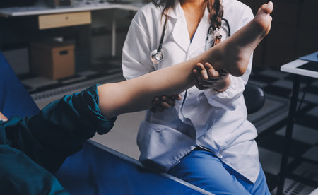 Rehabilitation therapy Professional male physiotherapists working in rehabilitation centers while treating male patients with leg and muscle pain.の写真素材